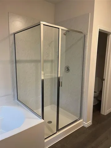 a bathroom with a glass shower door