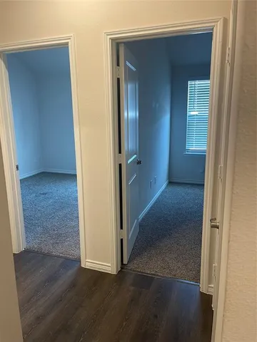 an empty room with wooden floor and closet