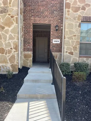 a balcony with a bench and potted plants