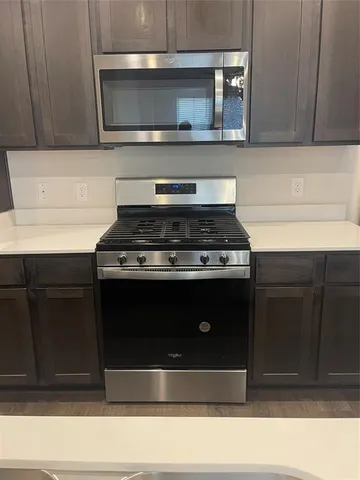 a stove top oven sitting inside of a kitchen