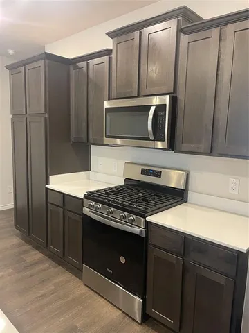 a kitchen with granite countertop cabinets and steel stainless steel appliances