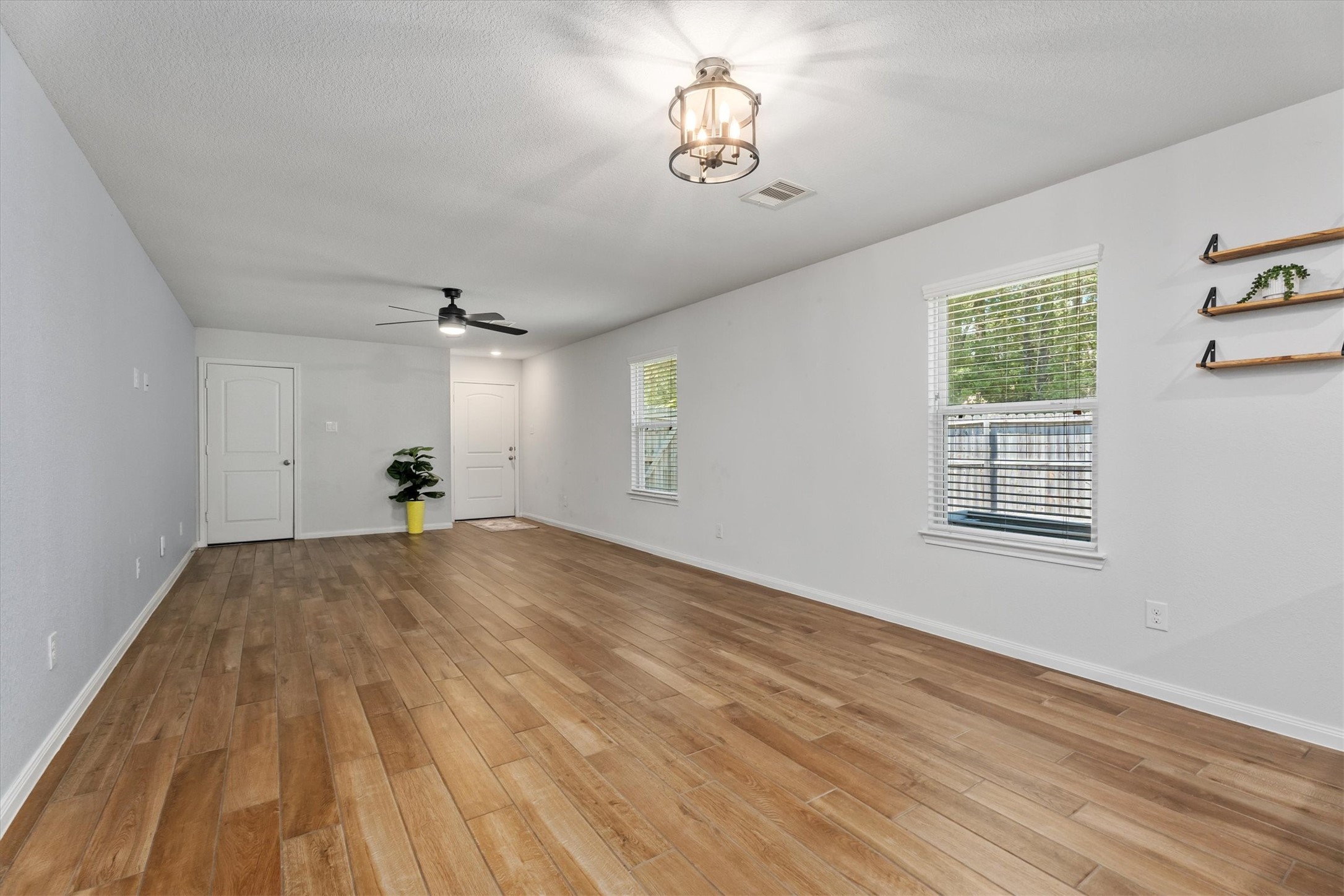 12912 Lake Conroe Bay Road Willis, TX 77318 - Photo 11 of 33 a view of empty room with wooden floor