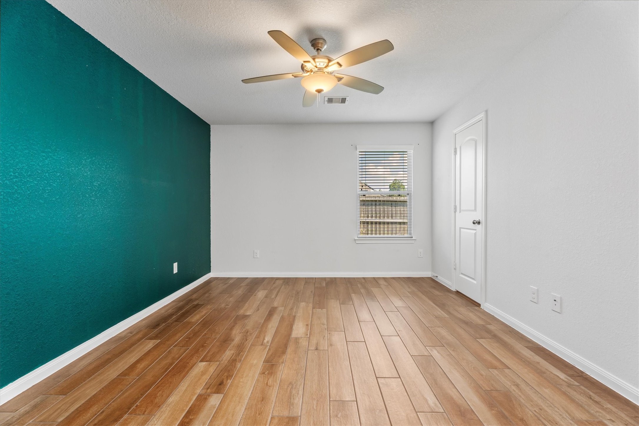 12912 Lake Conroe Bay Road Willis, TX 77318 - Photo 15 of 33 wooden floor in an empty room with a window