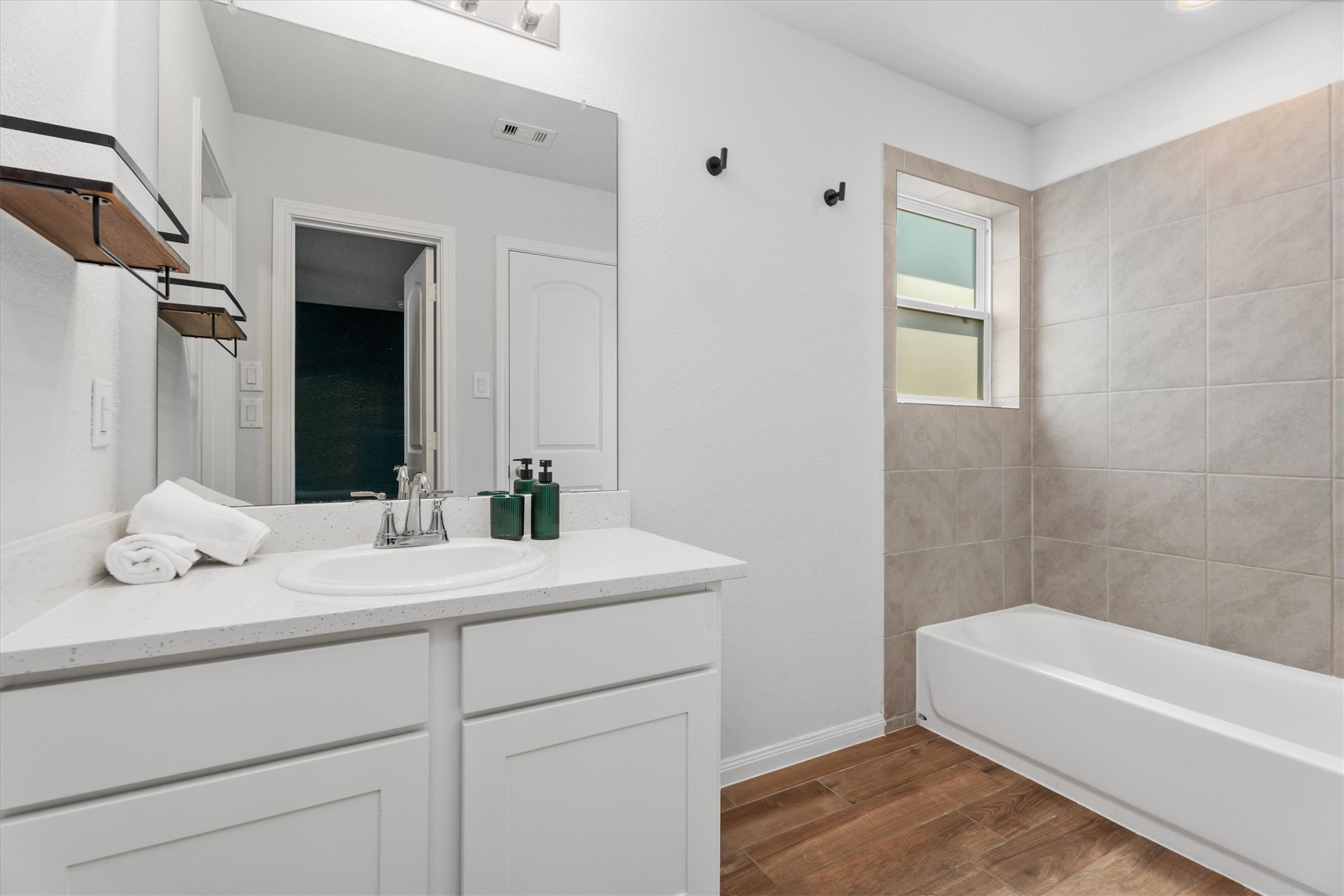 12912 Lake Conroe Bay Road Willis, TX 77318 - Photo 18 of 33 a bathroom with a sink a vanity and tub