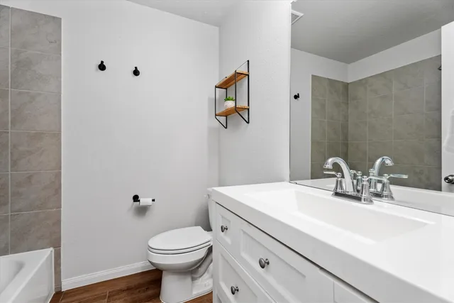 a bathroom with a sink a toilet and mirror