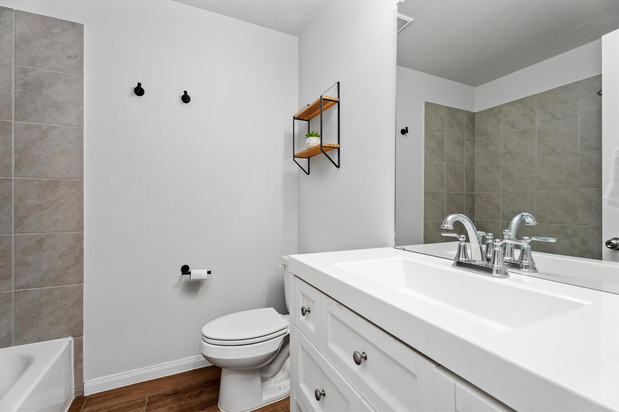 12912 Lake Conroe Bay Road Willis, TX 77318 - Photo 20 of 33 a bathroom with a sink a toilet and mirror