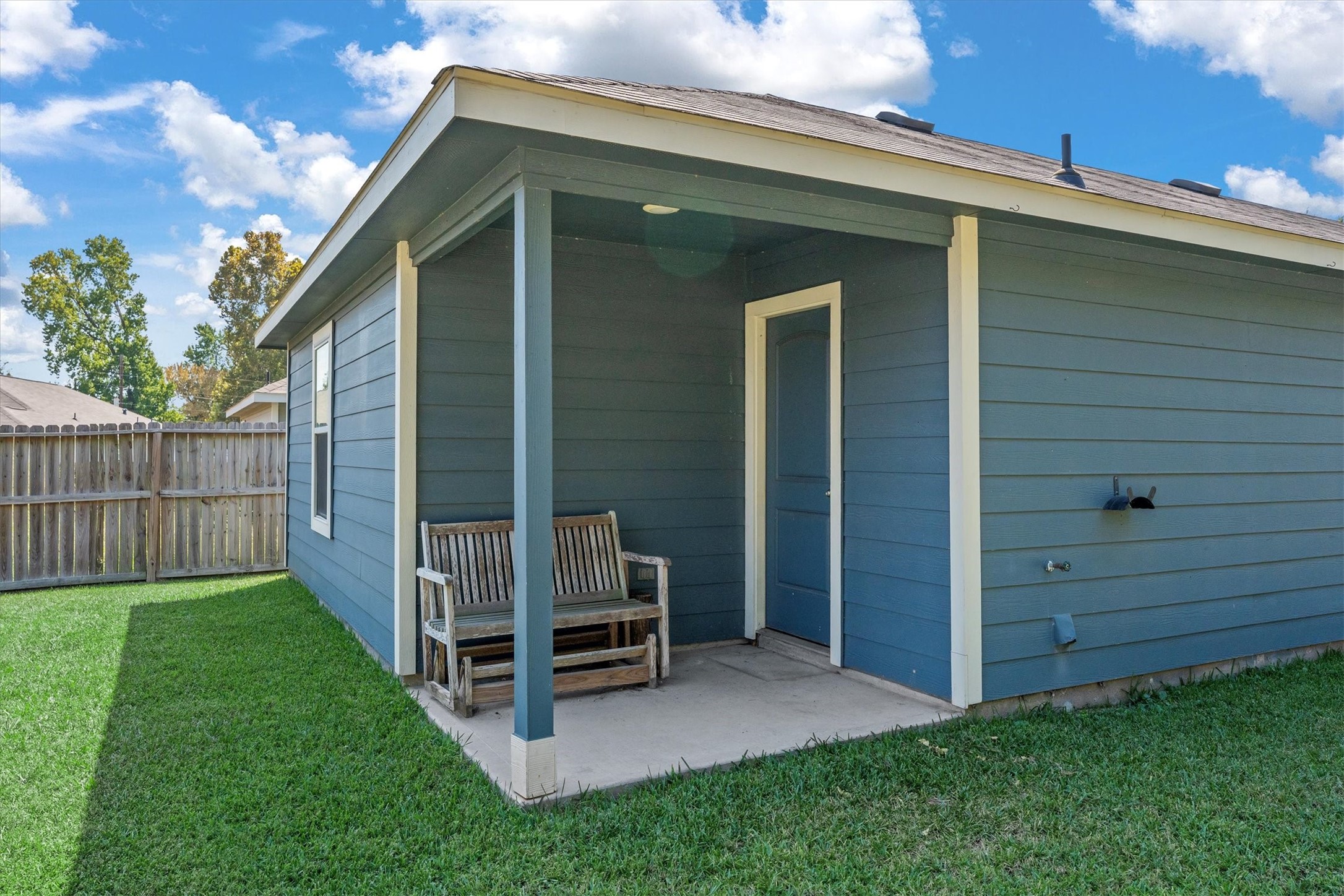 12912 Lake Conroe Bay Road Willis, TX 77318 - Photo 22 of 33 a view of backyard with wooden fence and a large tree