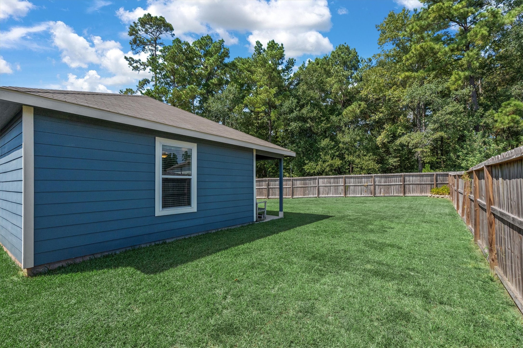12912 Lake Conroe Bay Road Willis, TX 77318 - Photo 26 of 33 a view of a backyard with potted plants and large tree