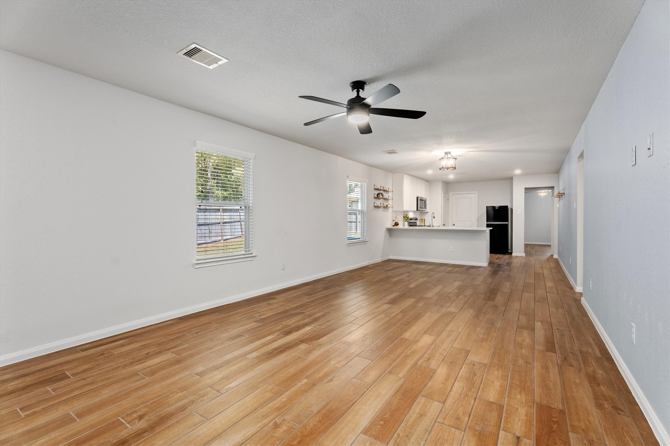 12912 Lake Conroe Bay Road Willis, TX 77318 - Photo 4 of 33 a view of empty room with wooden floor and windows