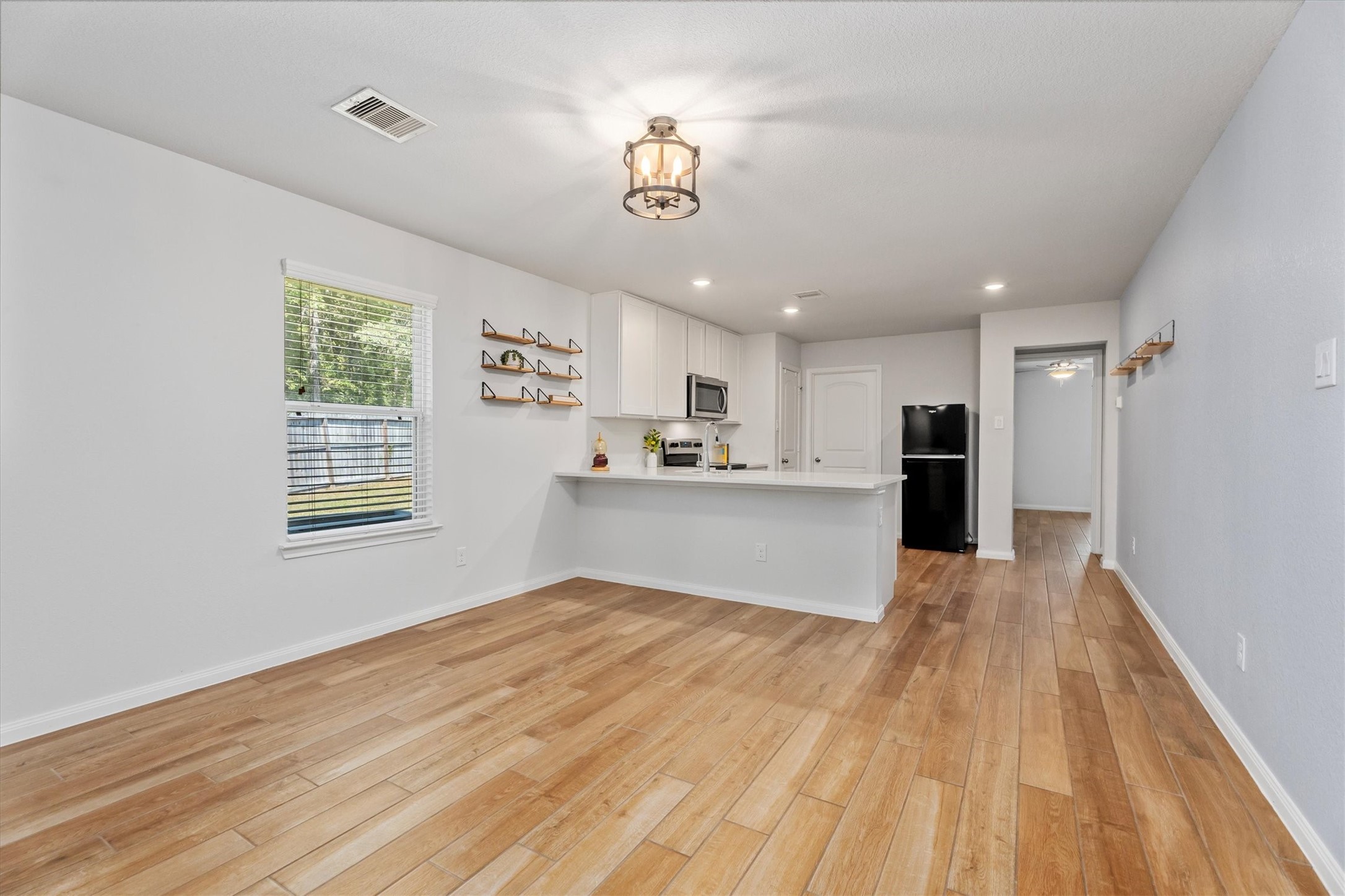 12912 Lake Conroe Bay Road Willis, TX 77318 - Photo 6 of 33 a view of kitchen and kitchen with wooden floor