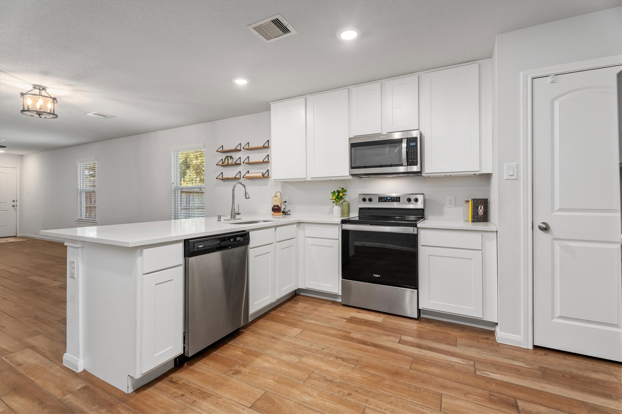 12912 Lake Conroe Bay Road Willis, TX 77318 - Photo 9 of 33 a kitchen with a white cabinets and appliances