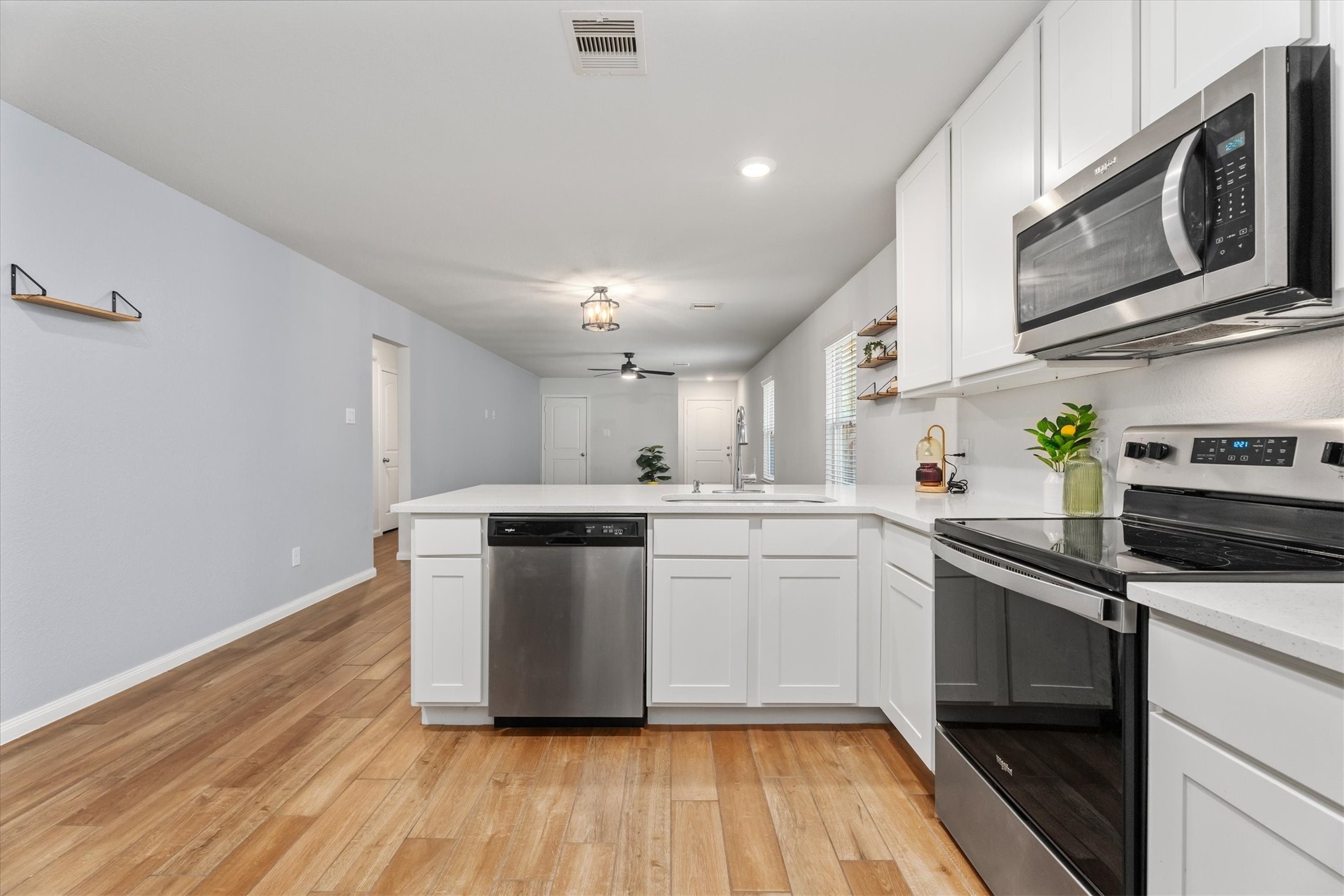 12912 Lake Conroe Bay Road Willis, TX 77318 - Photo 10 of 33 a kitchen with stainless steel appliances a white stove top oven and sink