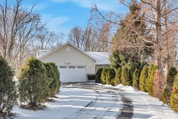 a view of a house with a yard covered with snow