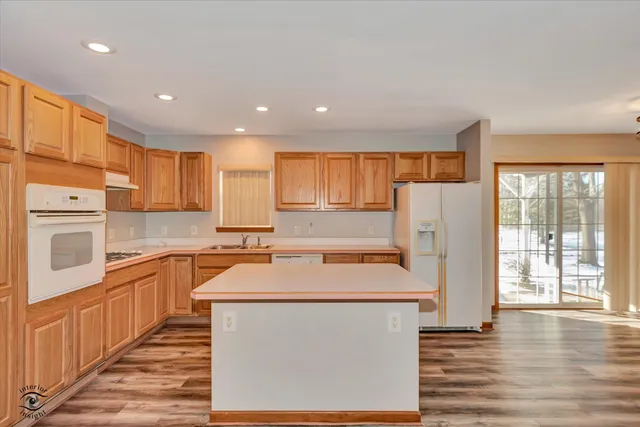 a kitchen with a refrigerator a stove top oven and a kitchen island