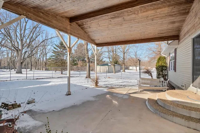 a view of a backyard with wooden fence