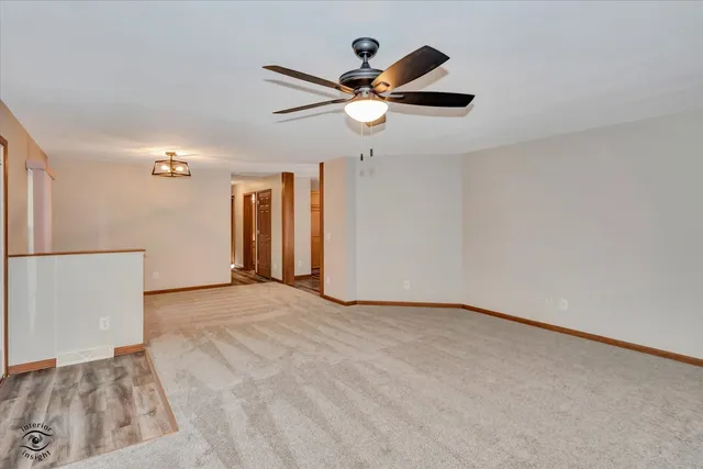 a view of a livingroom with a ceiling fan and window