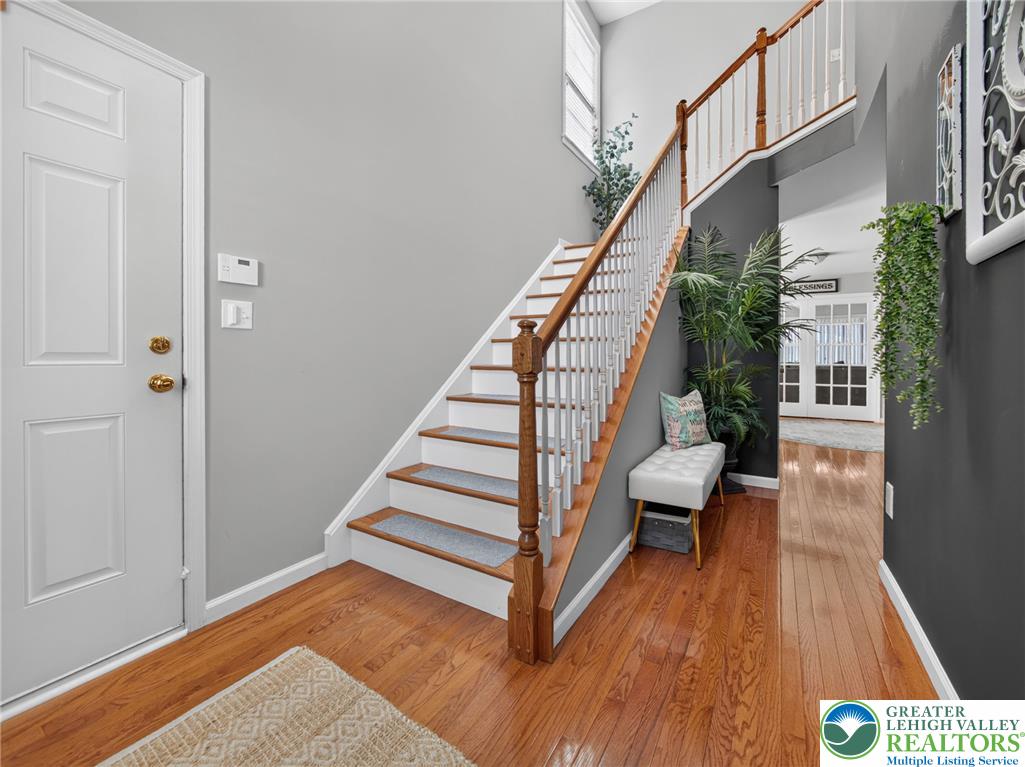 4148 Ross Road Bethlehem, PA 18020 - Photo 20 of 67 A grand staircase with rich hardwood flooring welcomes guests into this inviting foyer.
