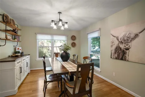 a view of a dining room with furniture window and wooden floor