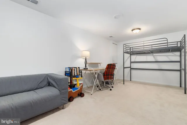 a living room with furniture and a chair