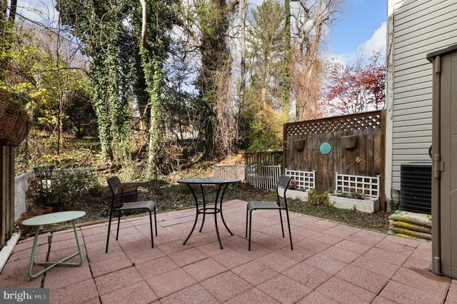 a view of a chairs and table in a backyard