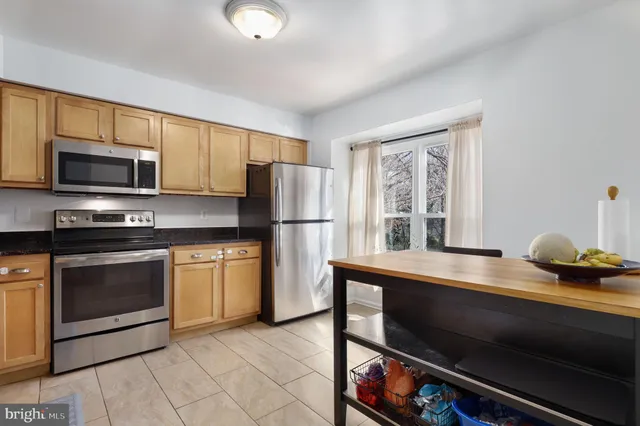 a kitchen with a refrigerator stove and microwave