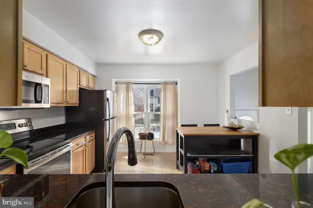 a dining room with furniture and a window