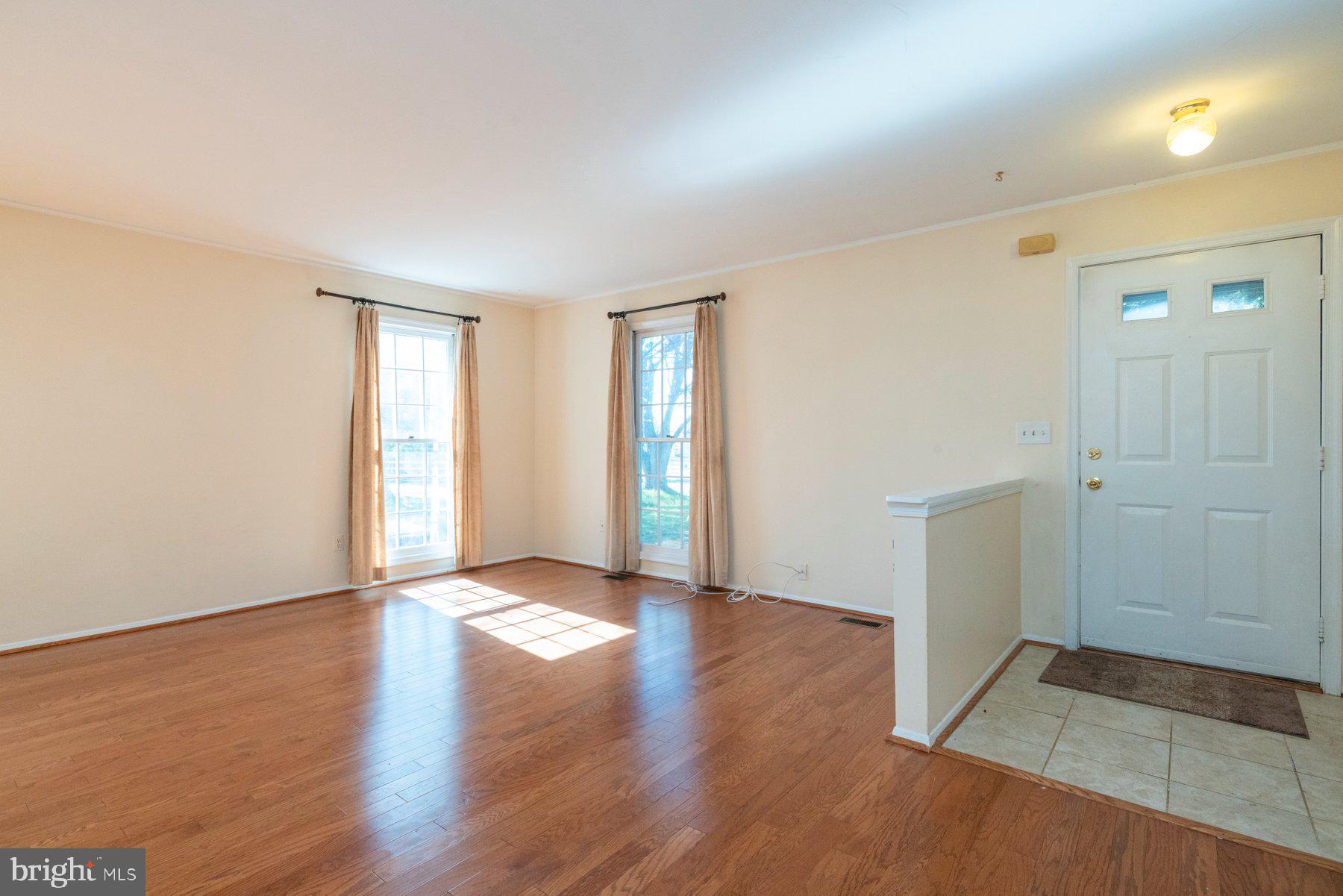 39 Triple Crown Court Gaithersburg, MD 20878 - Photo 5 of 26 an empty room with wooden floor and windows