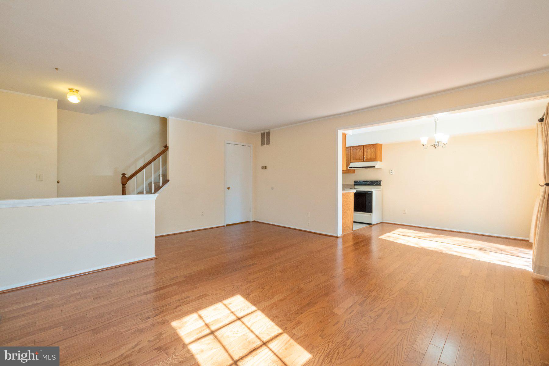 39 Triple Crown Court Gaithersburg, MD 20878 - Photo 6 of 26 a view of an empty room with wooden floor and a window