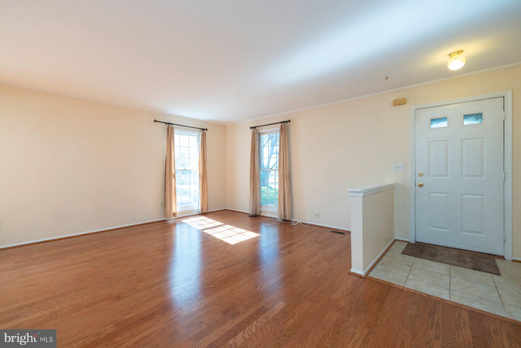 39 Triple Crown Court Gaithersburg, MD 20878 - Photo 7 of 26 an empty room with wooden floor and window