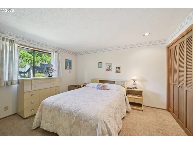 a bedroom with a bed and a large window