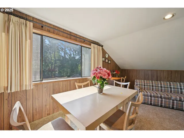 a view of a dining room with furniture and a large window