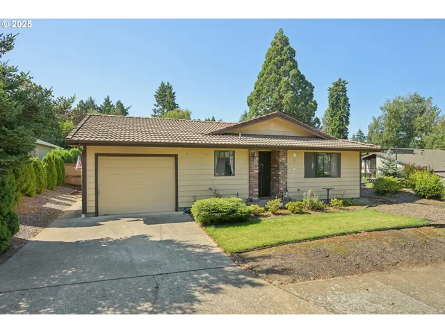 a front view of a house with a garden and plants