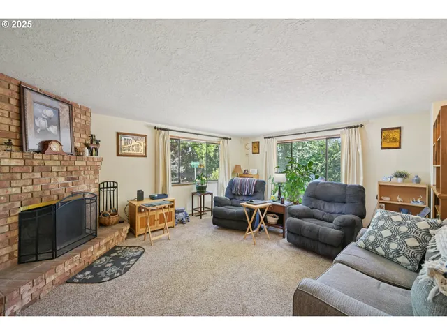 a living room with furniture a window and a fireplace