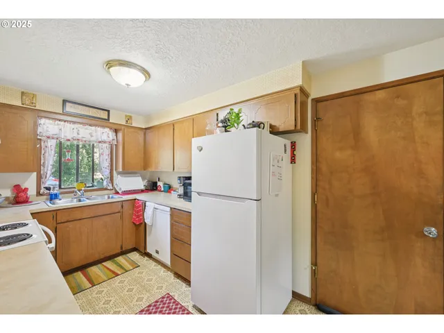 a kitchen with a refrigerator and a sink