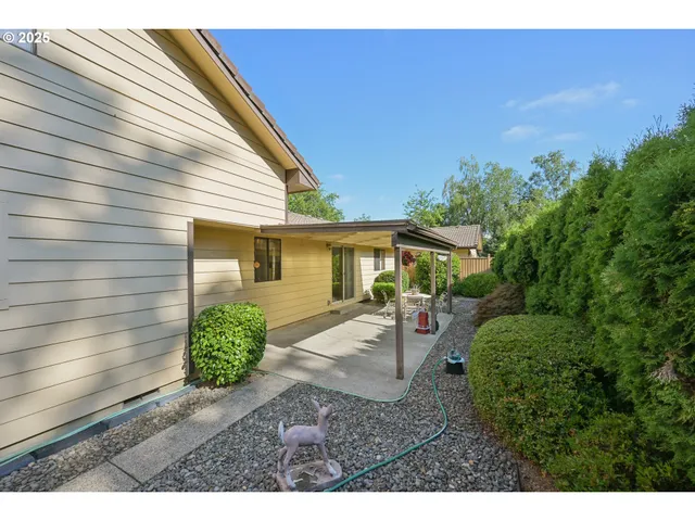 a view of a house with backyard and sitting area