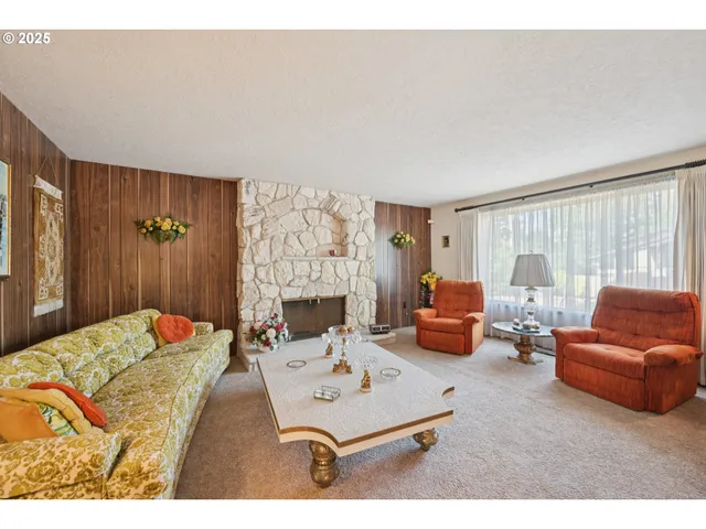 a bedroom with furniture and a large window