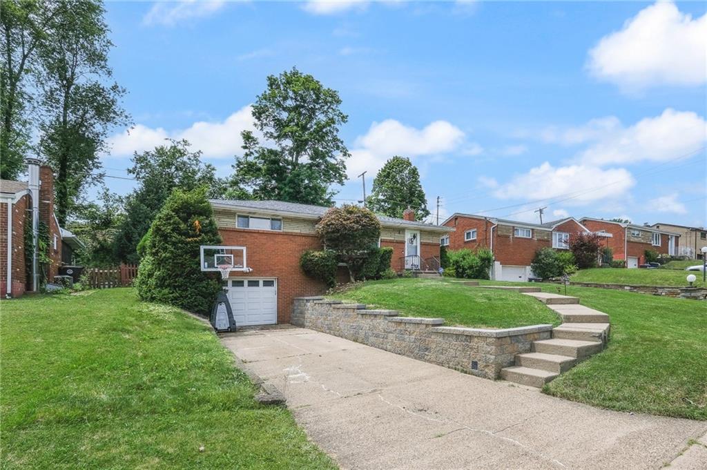 1654 Hollyrood Road Pittsburgh, PA 15227 - Photo 2 of 33 a front view of a house with a yard and trees
