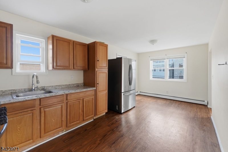 172 Carroll Street Paterson, NJ 07501 - Photo 20 of 48 a kitchen with stainless steel appliances granite countertop a refrigerator and a sink