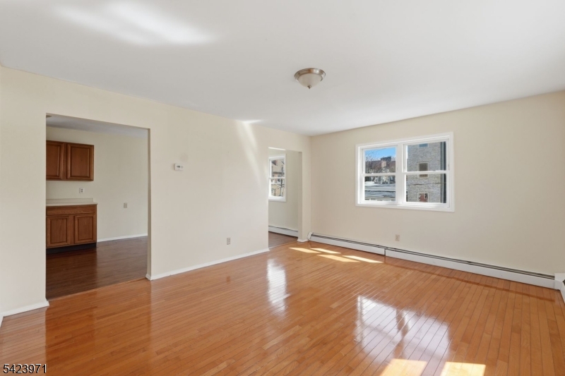 172 Carroll Street Paterson, NJ 07501 - Photo 33 of 48 a view of empty room with wooden floor and fan