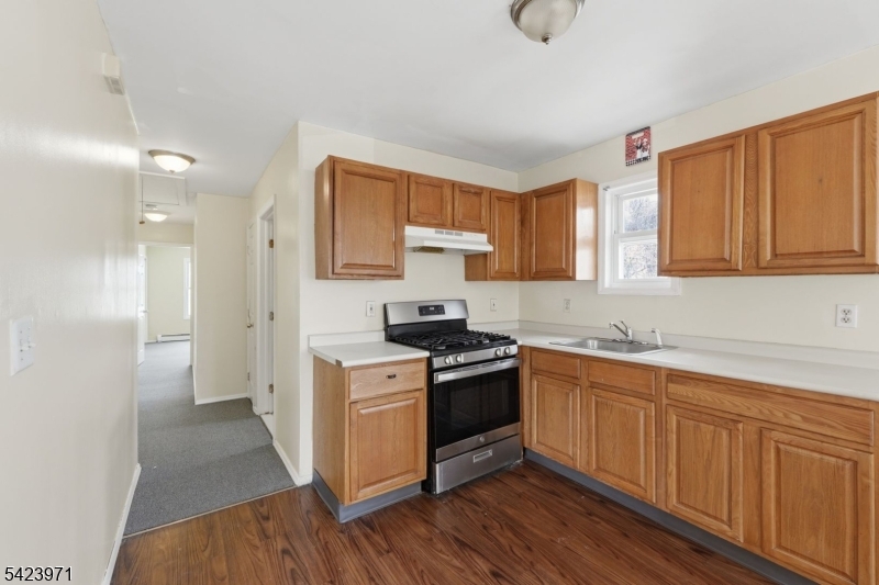 172 Carroll Street Paterson, NJ 07501 - Photo 36 of 48 a kitchen with stainless steel appliances granite countertop a sink stove and refrigerator