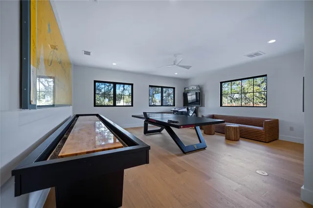 a living room with furniture pool table and a window