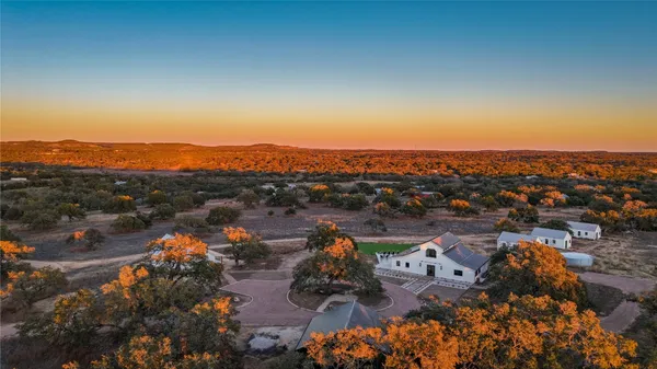 an aerial view of a house with a lake view