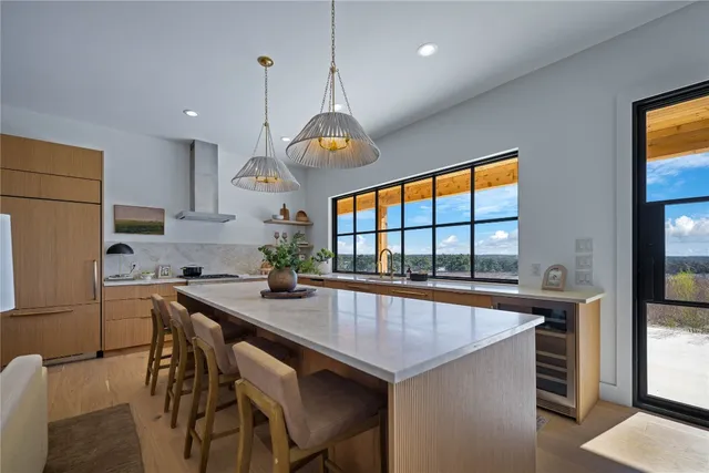 a kitchen with a table chairs sink and cabinets