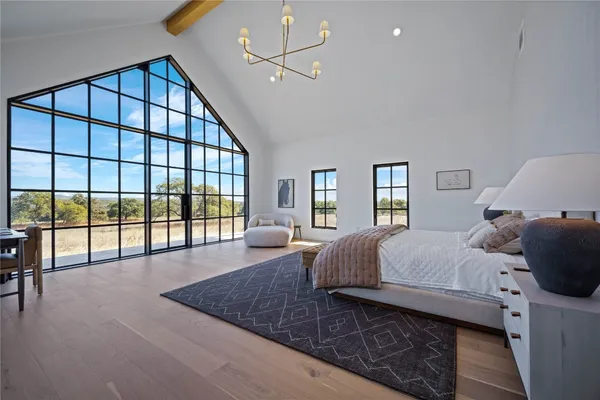 a spacious bedroom with a large bed and a large window