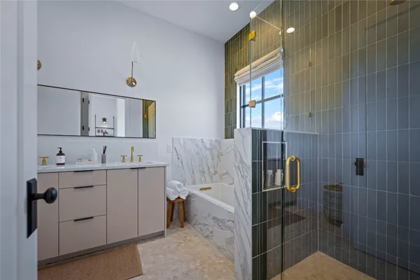 a bathroom with a double vanity sink toilet and shower