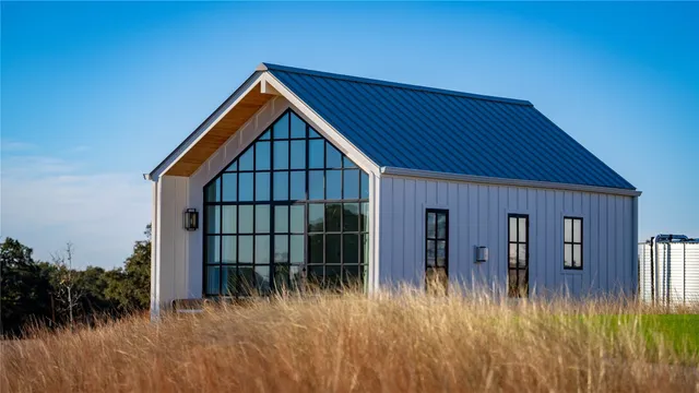 a view of front of house with deck area and swimming pool