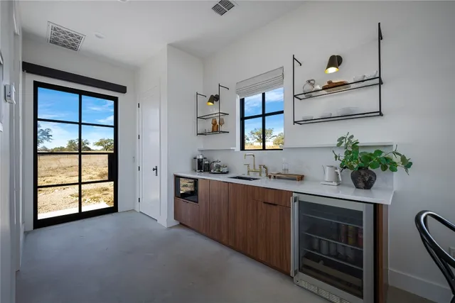 a kitchen with stainless steel appliances a sink stove and microwave