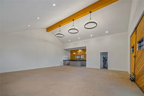 an empty room with a fireplace and a large window