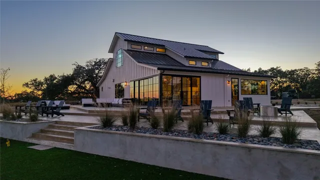 a front view of a house with sitting area and garden