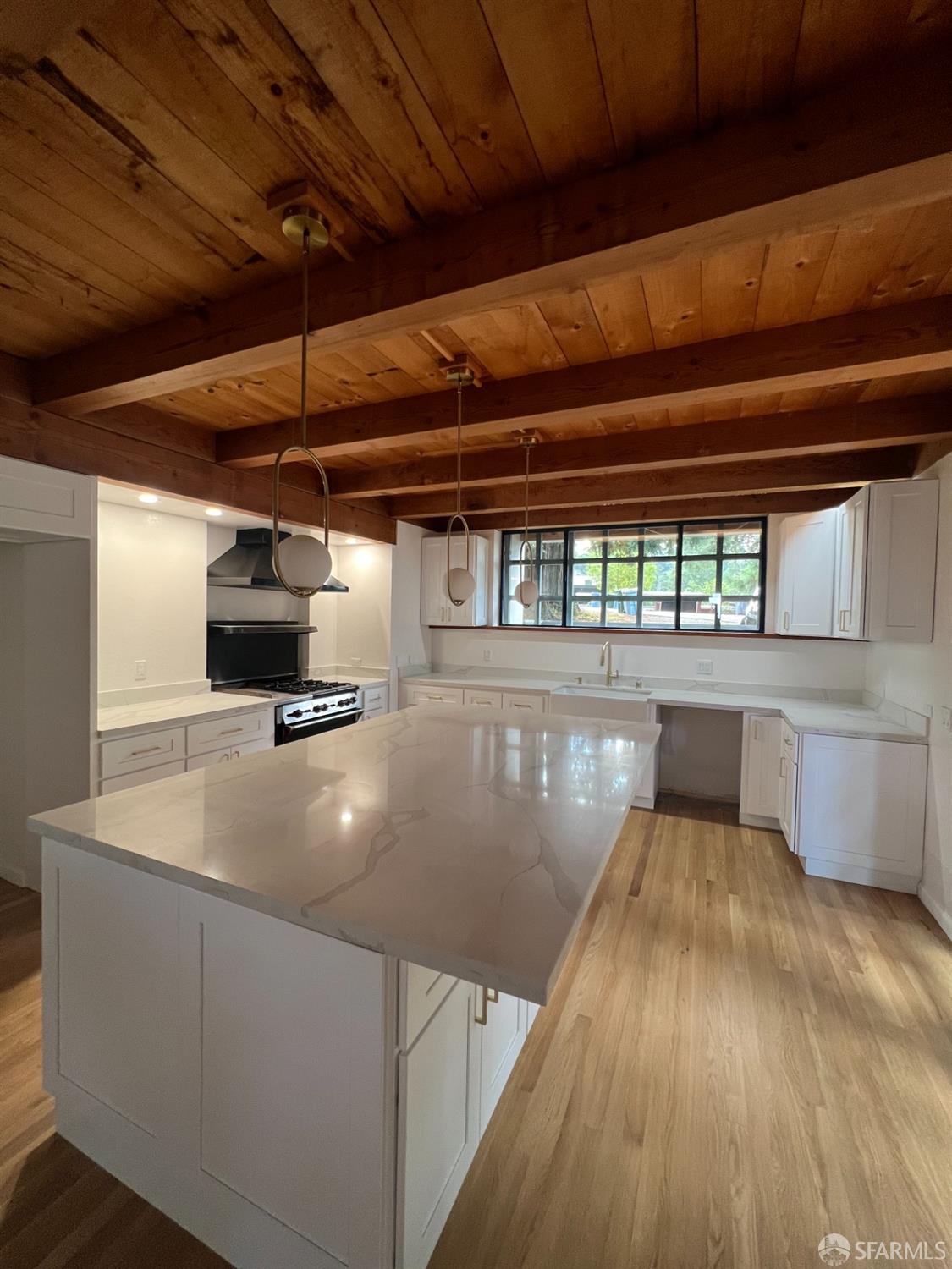 a view of a kitchen with a sink and wooden floor
